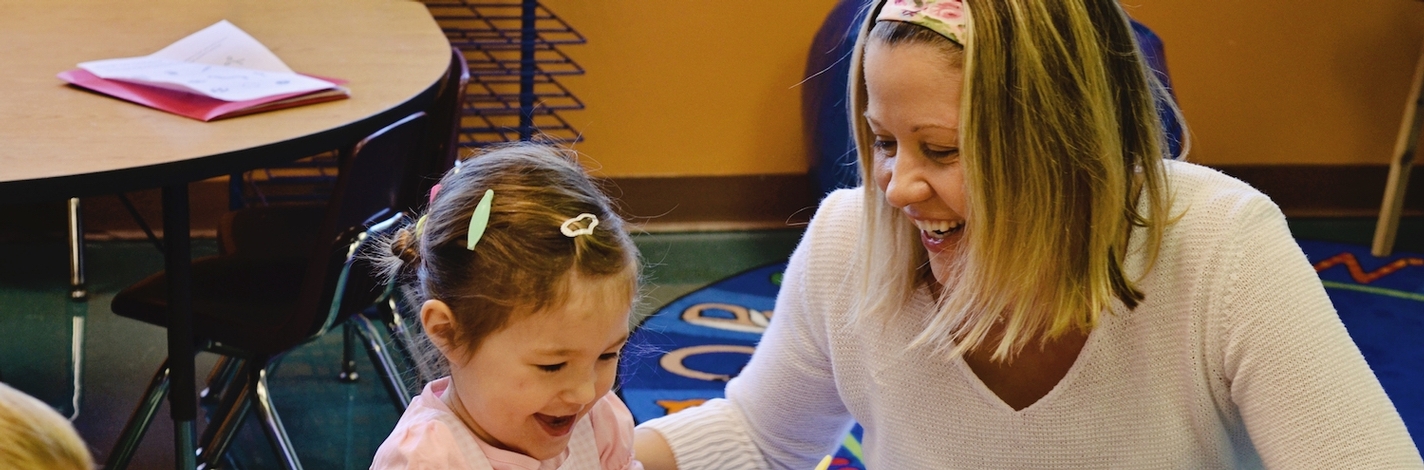 kindergarten teacher with student